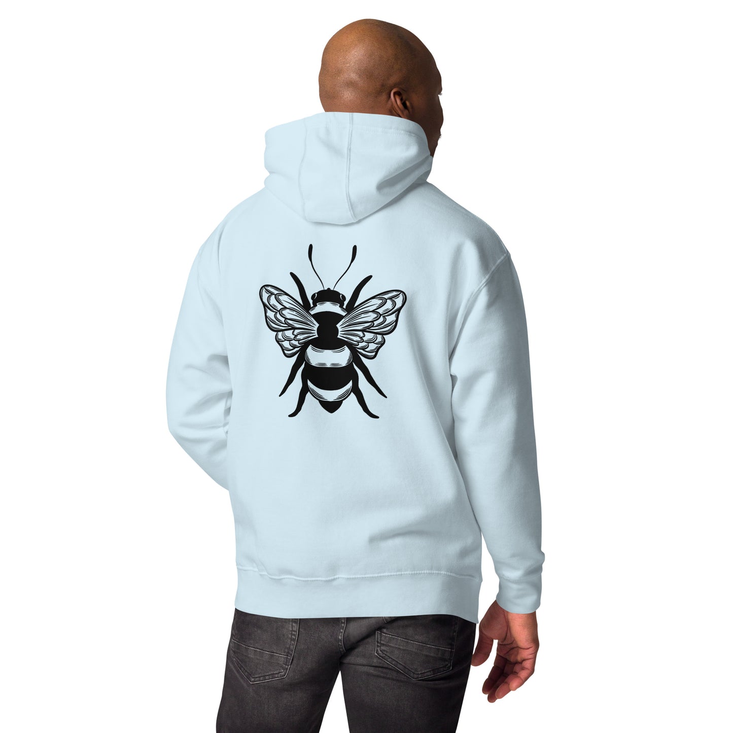 Man in a light blue hoodie with a large black bee graphic on the back, wearing dark jeans.