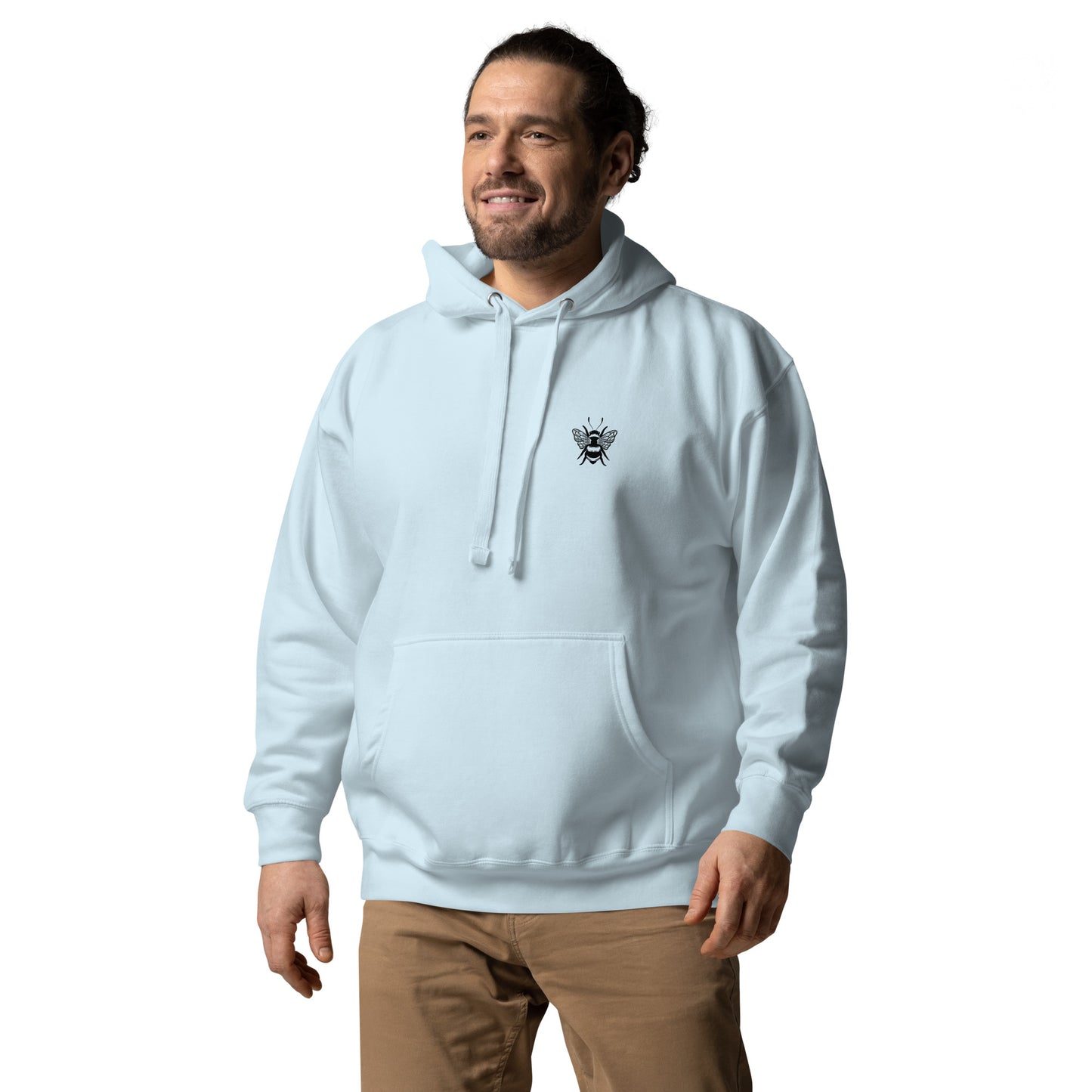 Man wearing a light blue hoodie with a small black bee graphic on the chest, paired with brown pants.